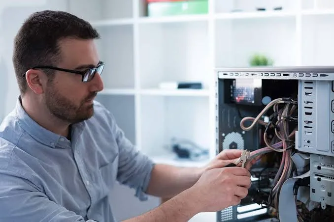 Technician repairing a business desktop computer
